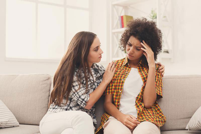 Two Girls Talking; One Of Them Consoling The Other