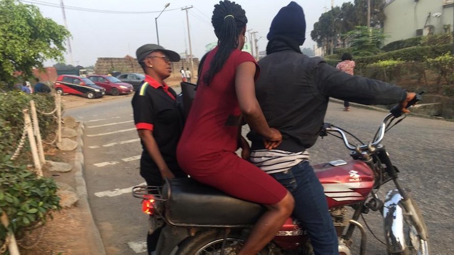 Nigerian Bike Man With Passengers